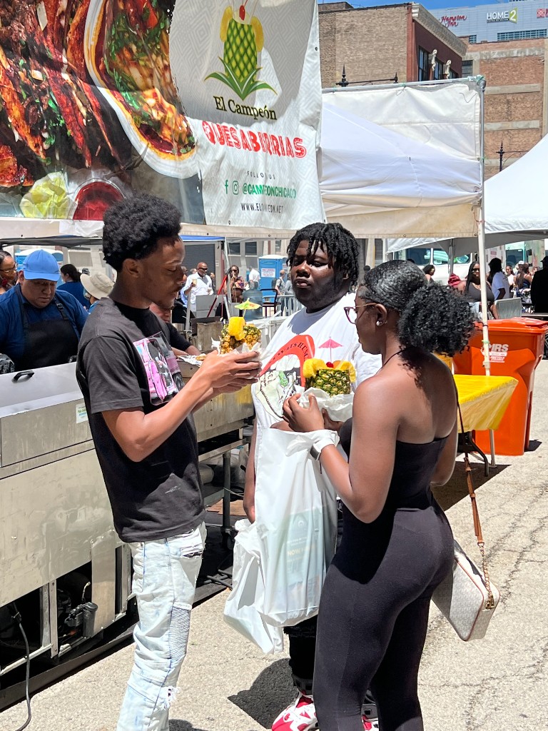 Crowds walking the festival route with food trucks in the South Loop