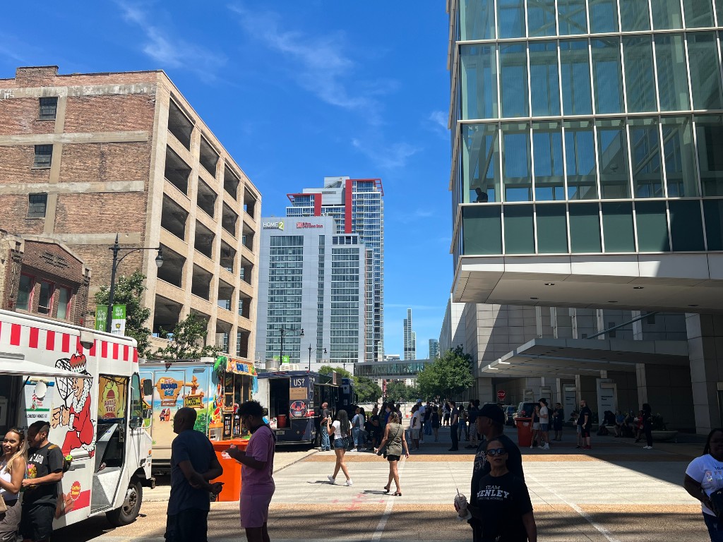 Food trucks and crowd on the sunny festival plaza in the South Loop
