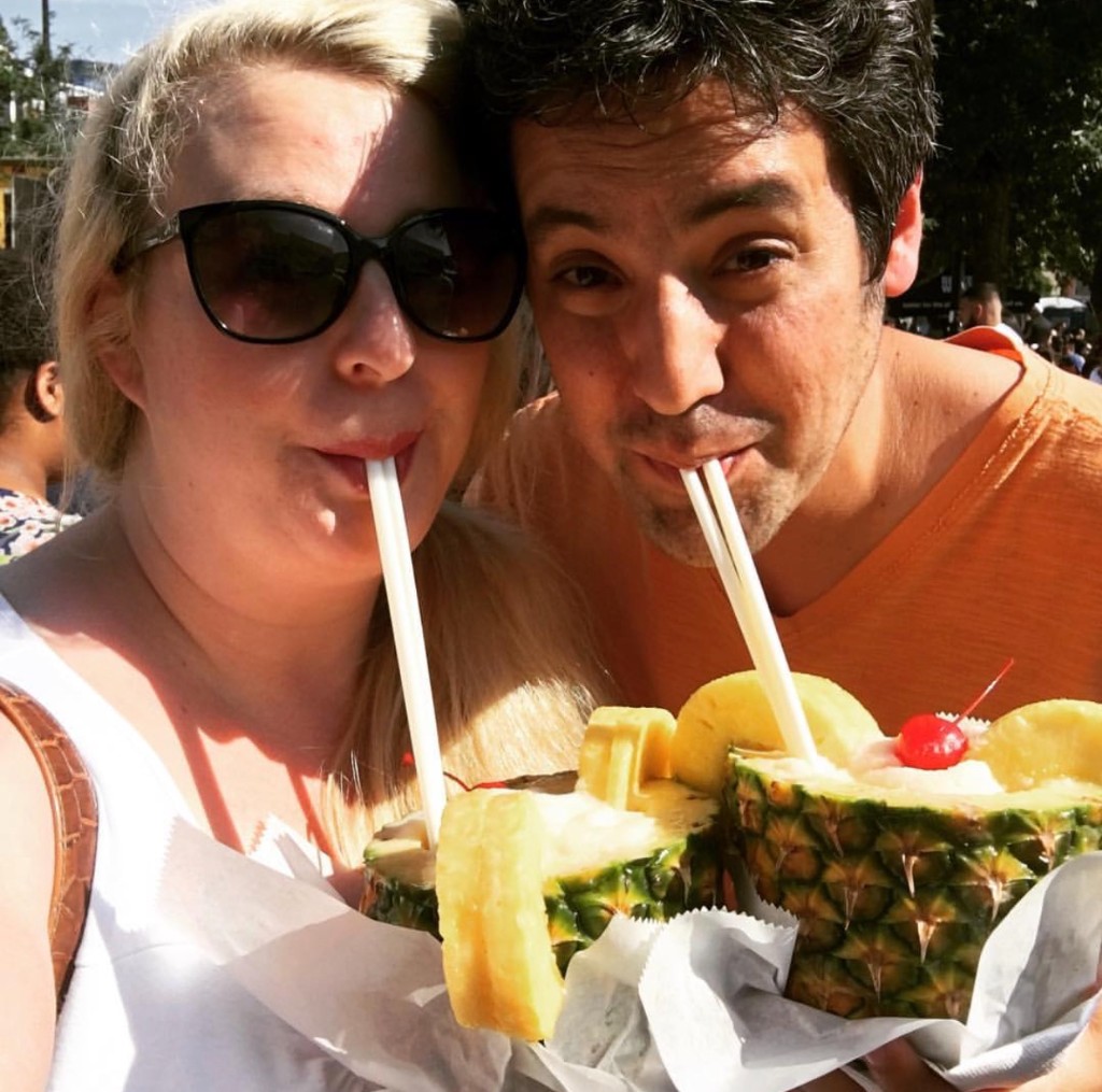 Three friends with drinks in front of food trucks including Happy Lobster at the South Loop festival