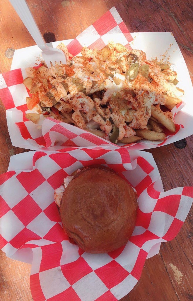 Chocolate-coated frozen treat from the Crave Bar held up against a blue sky at the festival