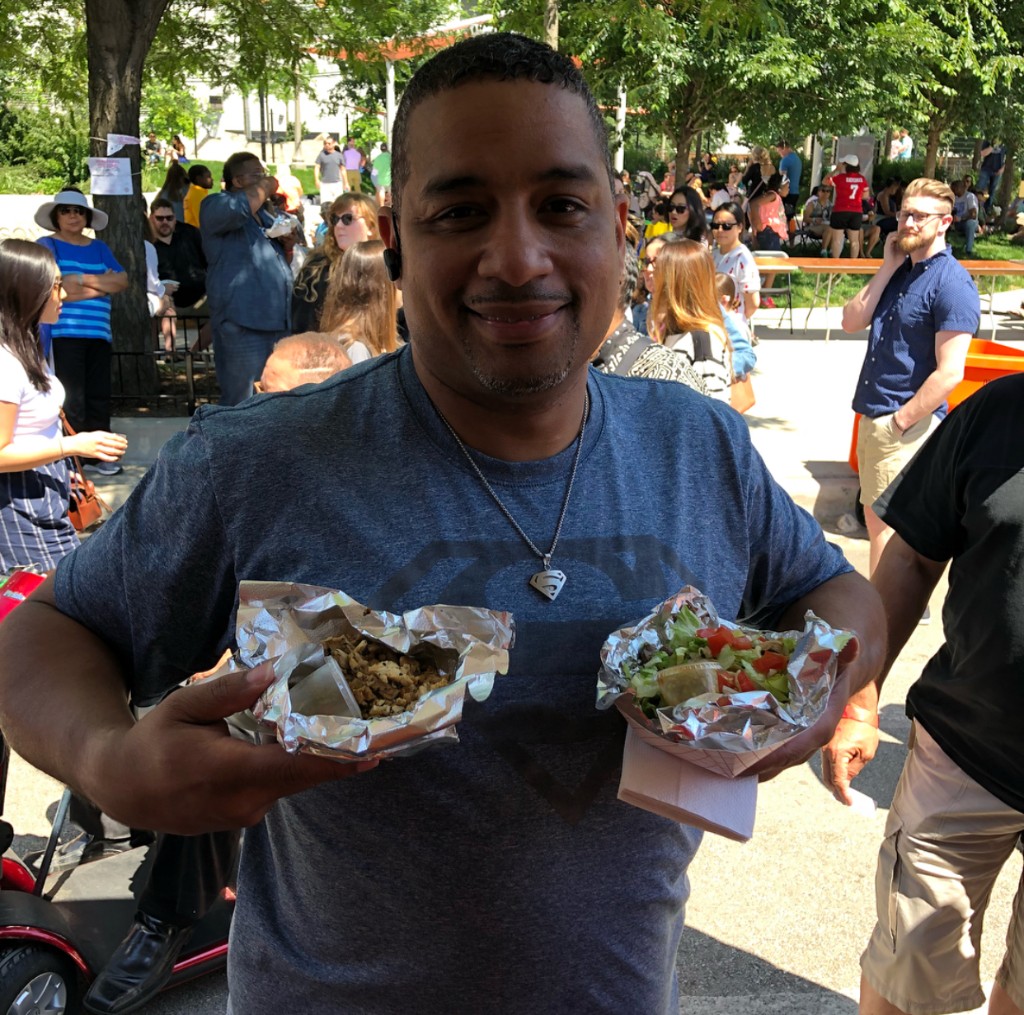 Crowd moving between canopies and trucks along the South Loop festival grounds