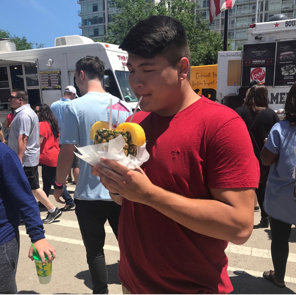 Guest with a pineapple drink at food trucks in the South Loop