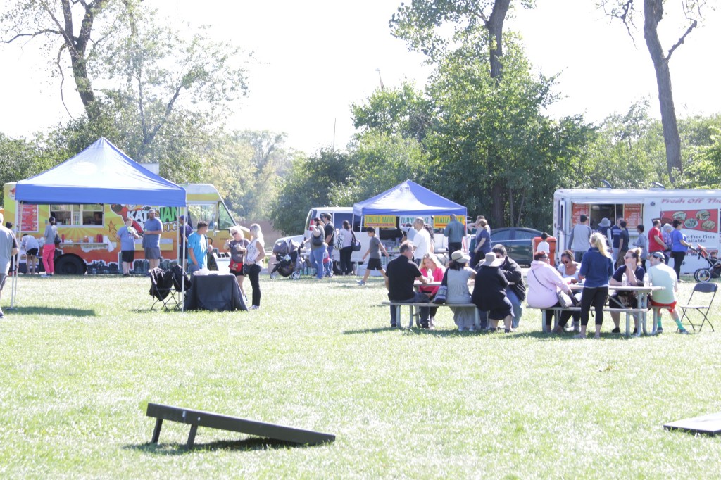 Food trucks and guests on the grass at the Labagh Woods Fall Festival.