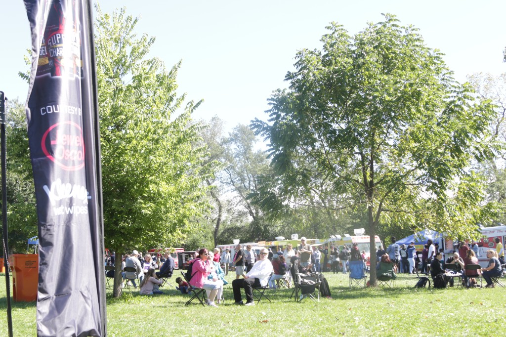 Guests with food and drinks at the Labagh Woods Fall Festival.