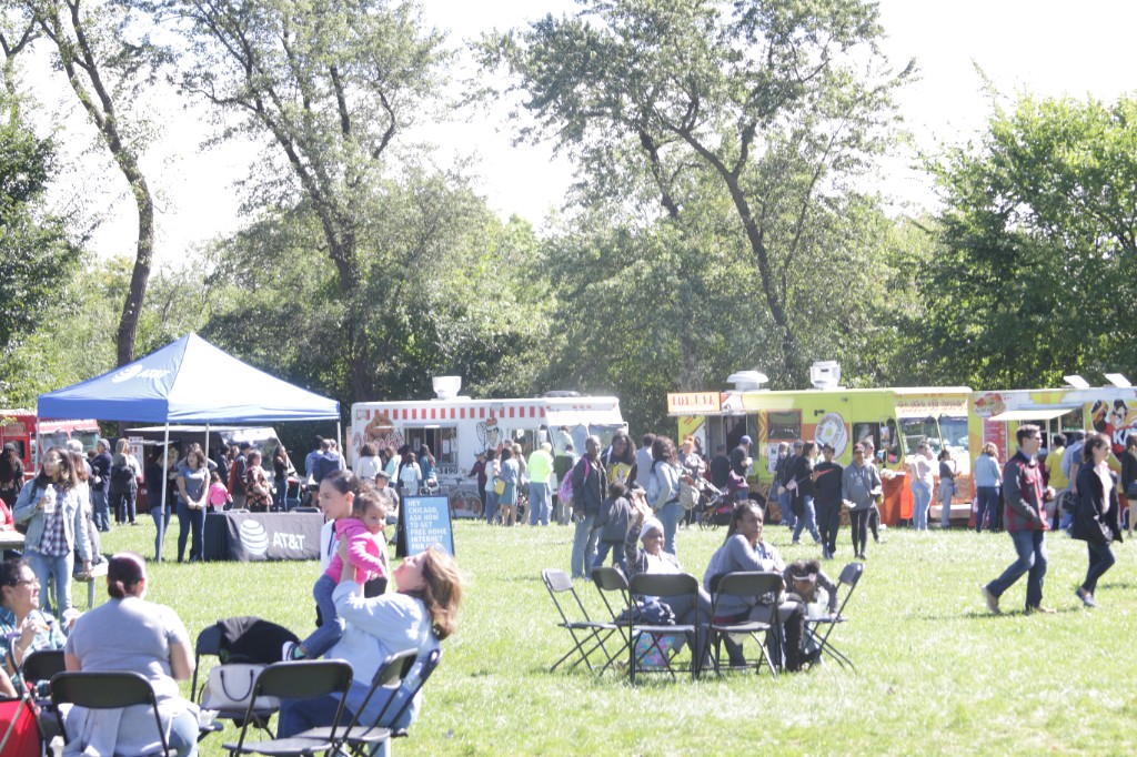 Open grass and busy vendor area at Labagh Woods.