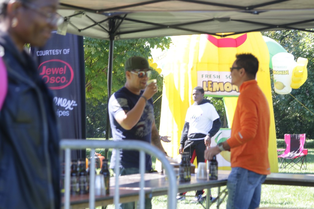 Guests seated and standing near festival tents at Labagh Woods.