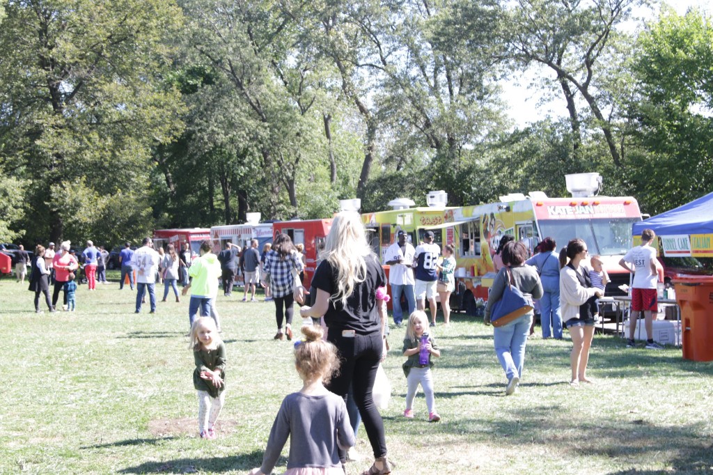 Festival energy: people, tents, and trucks at Labagh Woods.