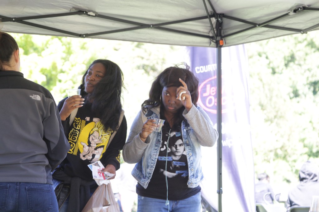 Guests carrying food across the grass at Labagh Woods.