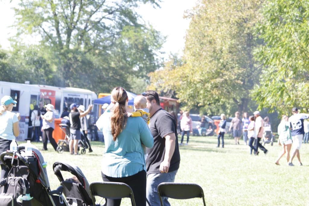 Guests seated near an El Campeón piña colada banner at the Labagh Woods Fall Festival.