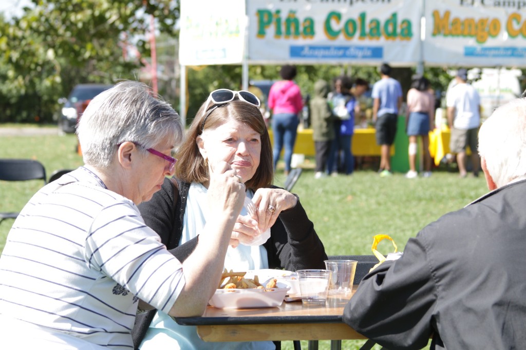 Two guests posing near festival drinks tents at Labagh Woods.
