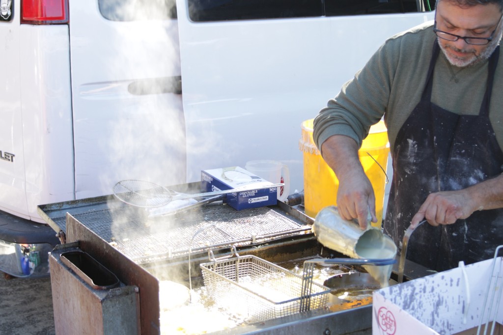 Artist face-painting a child in a festival chair at the Labagh Woods Fall Festival.
