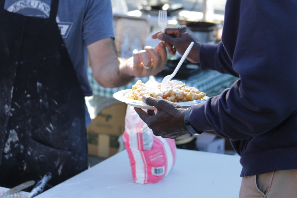 Guests enjoying food beside a bright red food truck at Labagh Woods.