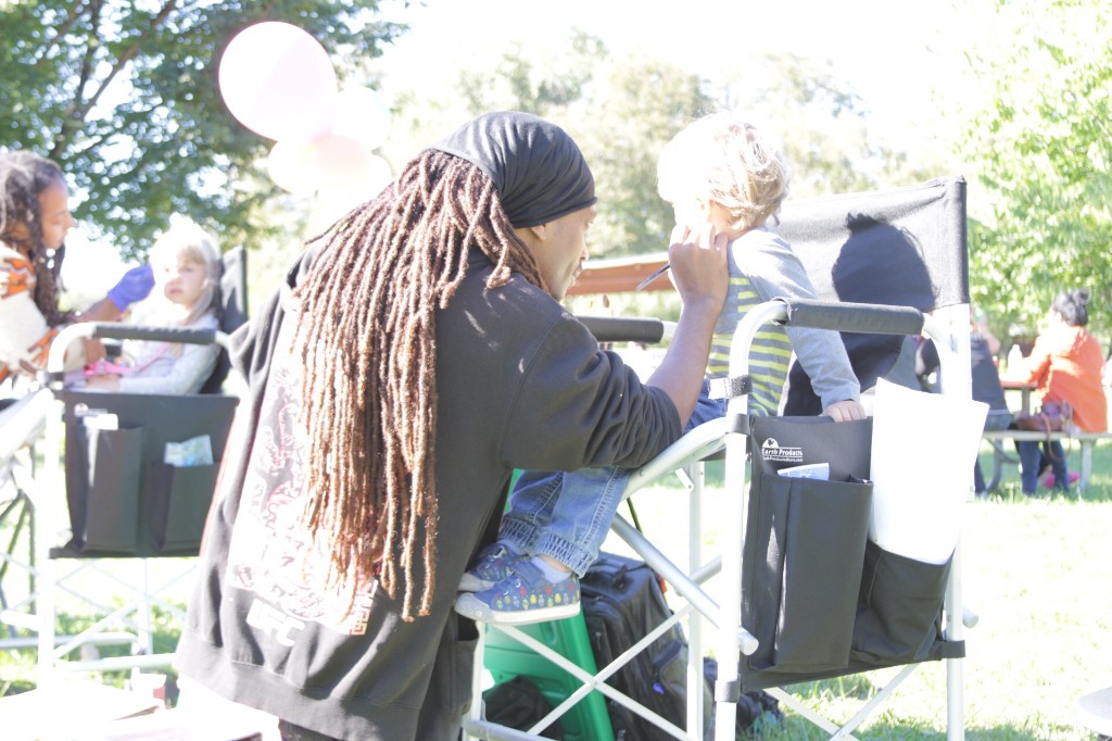 Picnic tables, food trucks, and an AT&T tent on the grass at Labagh Woods.