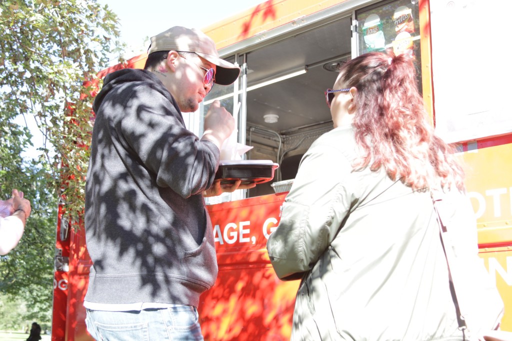 Crowds, picnic tables, and food trucks on a sunny fall day at Labagh Woods.