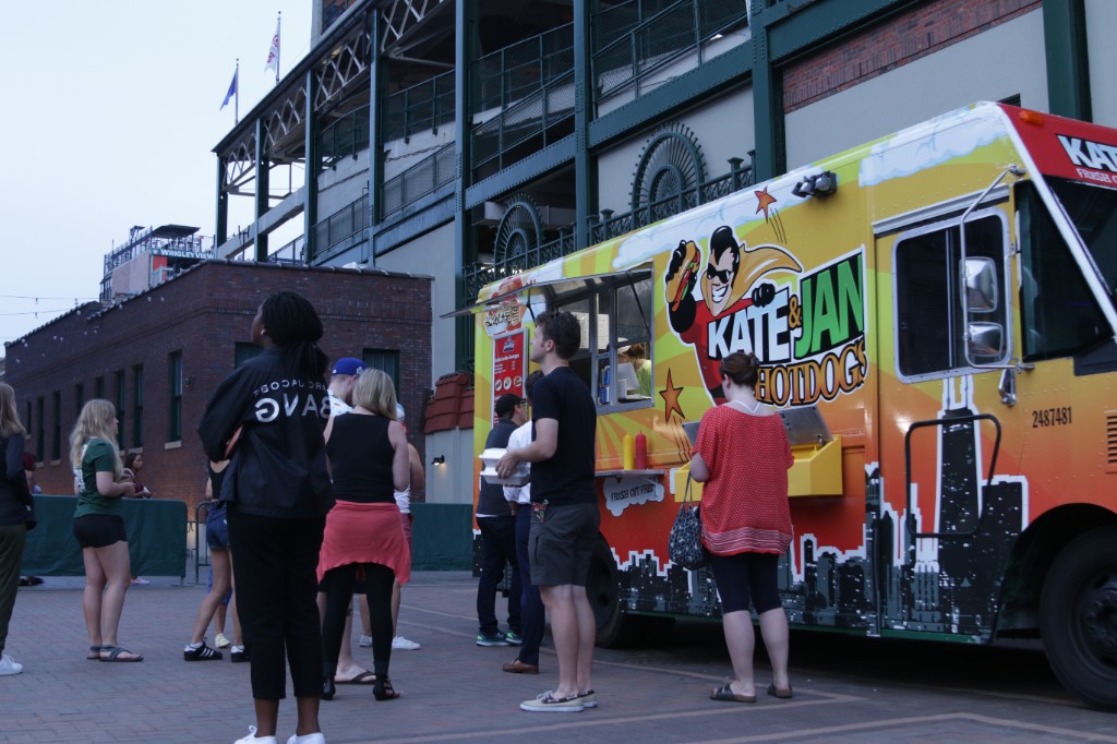 Kate & Jan Hotdogs truck and fans outside Wrigley Field on a sunny game day