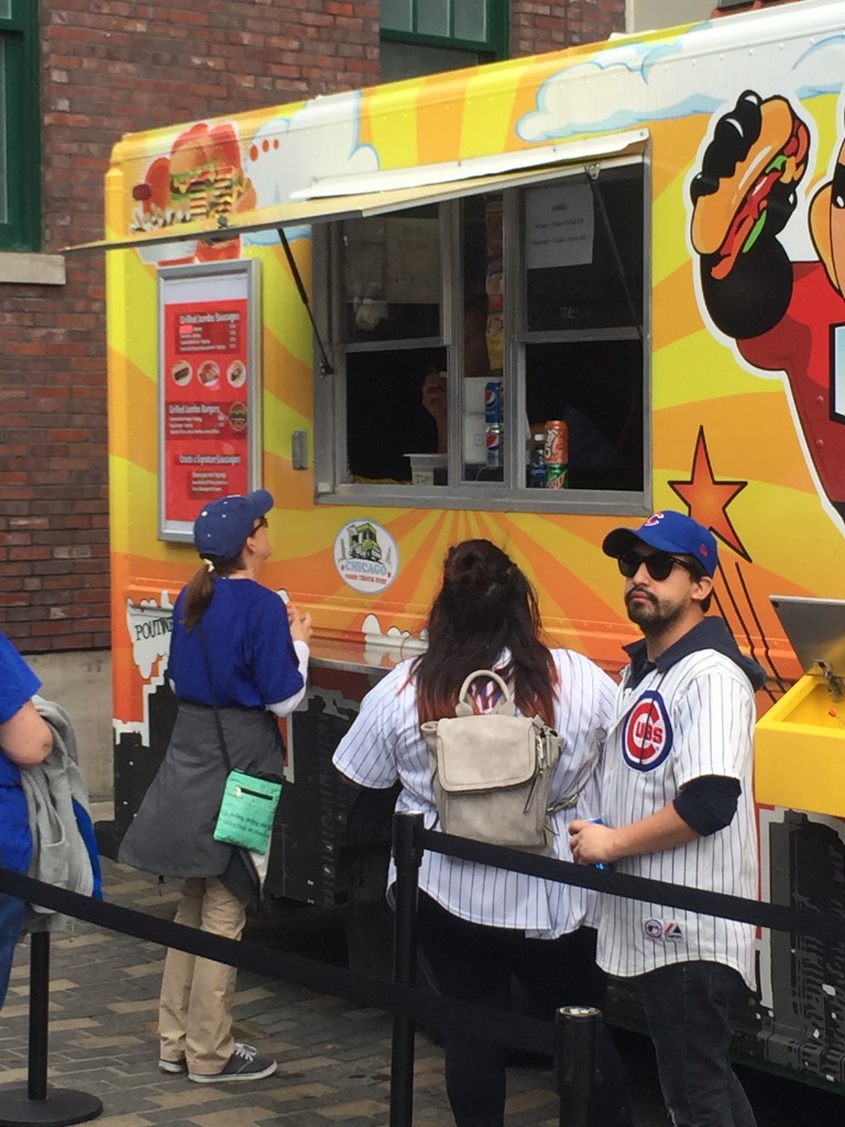 Crowd and Kate & Jan Hotdogs truck outside Wrigley Field
