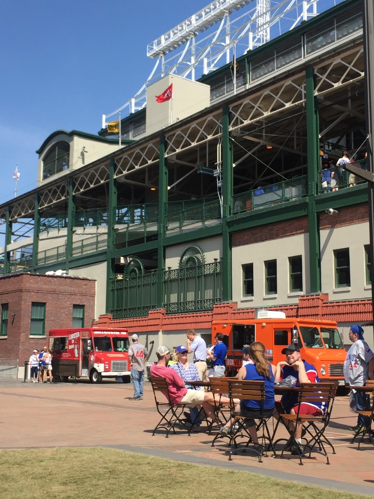 Gallagher Way plaza with food trucks and outdoor seating outside Wrigley Field