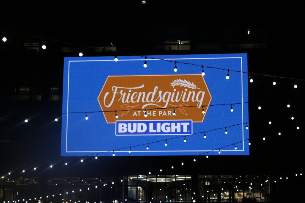 Stage speakers and rigging at the Friendsgiving concert with building windows behind