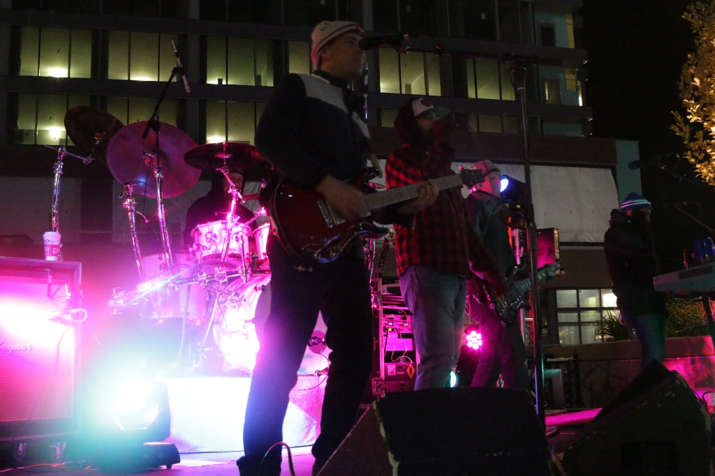 Evening lawn gathering beside the green steelwork of Wrigley Field during Friendsgiving