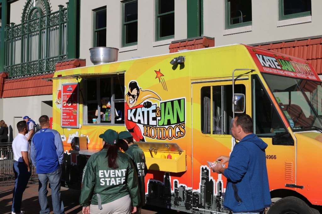 Large outdoor screen showing a Cubs game for fans on Gallagher Way