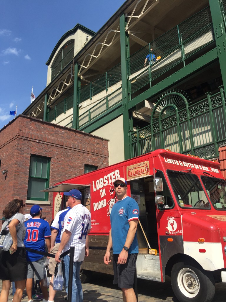 Da LOBSTA lobster truck beside the green exterior of Wrigley Field