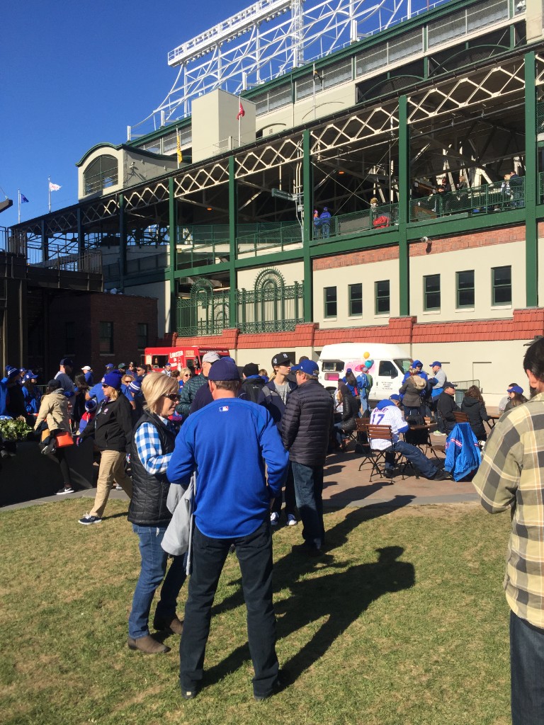 Fans in Cubs gear gathered near food trucks outside Wrigley Field