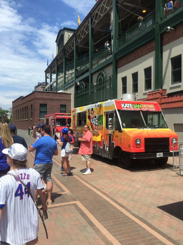 Kate & Jan Hotdogs truck on the brick walkway with Wrigley Field behind
