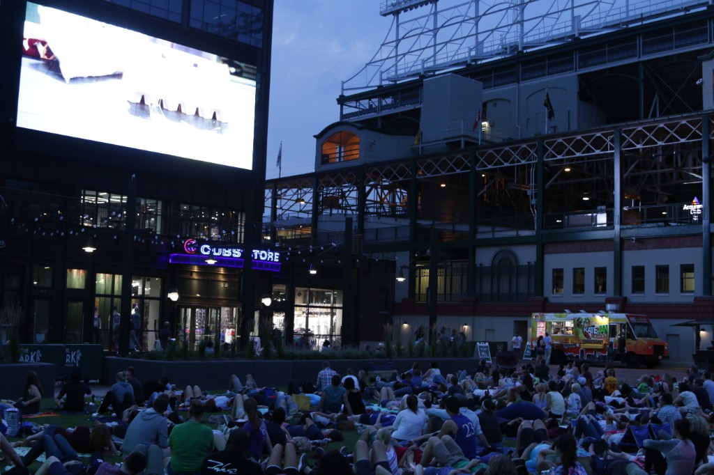 Blankets on the lawn as people watch the outdoor movie after sunset at Gallagher Way