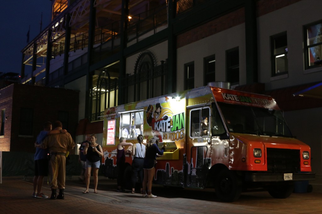 Kate & Jan Hotdogs truck lighting up the plaza as people order during movie night